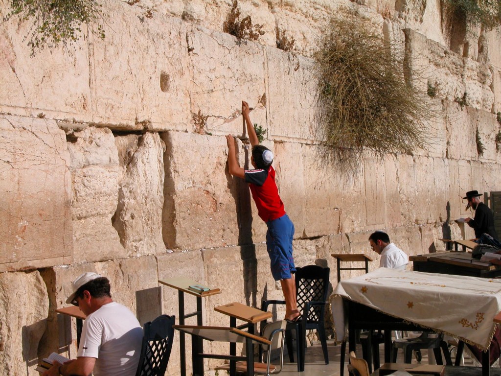 Man putting prayer in Western Wall, tb092603035